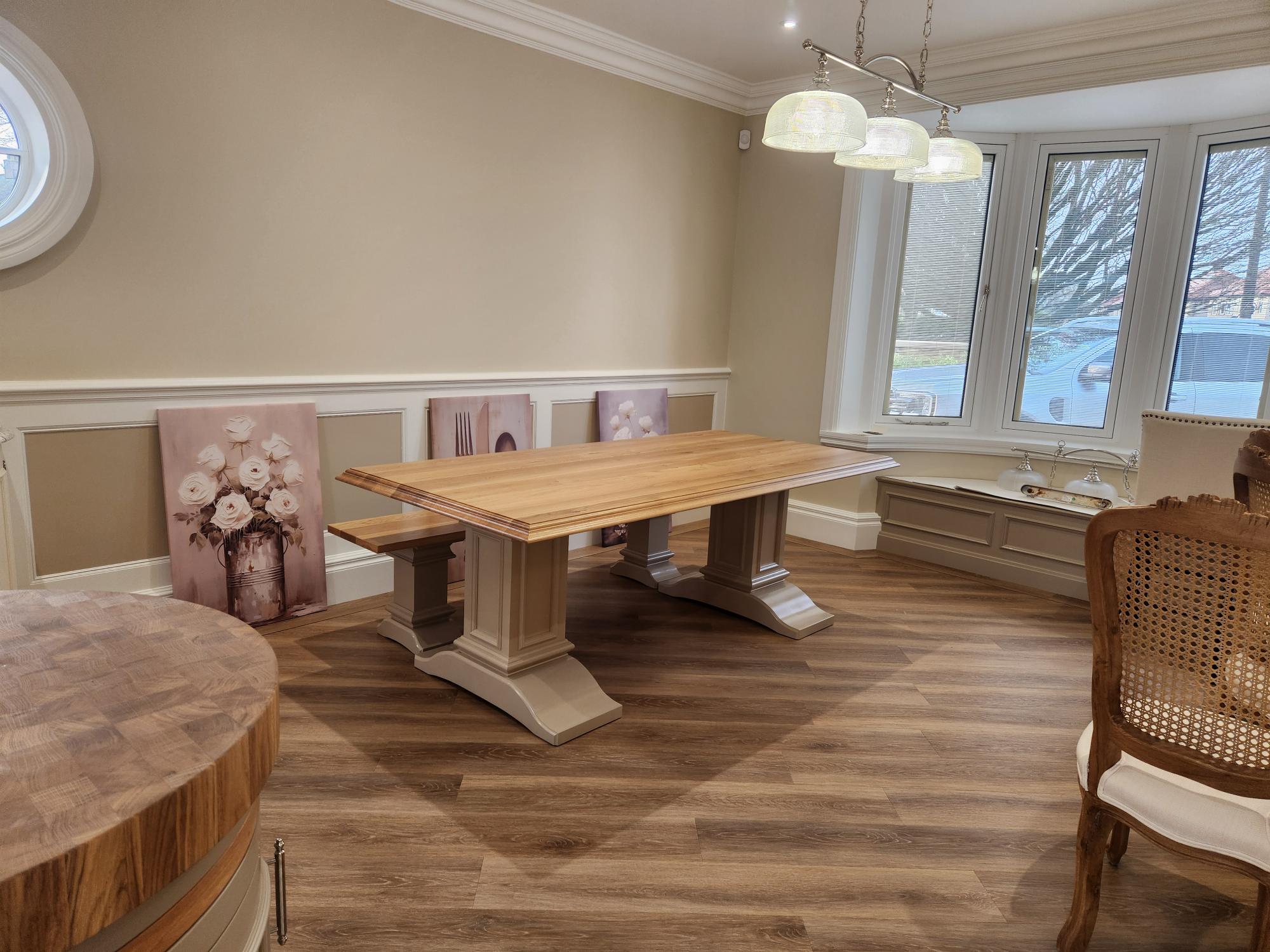 Bespoke oak trestle dining table with window seat and wall panelling