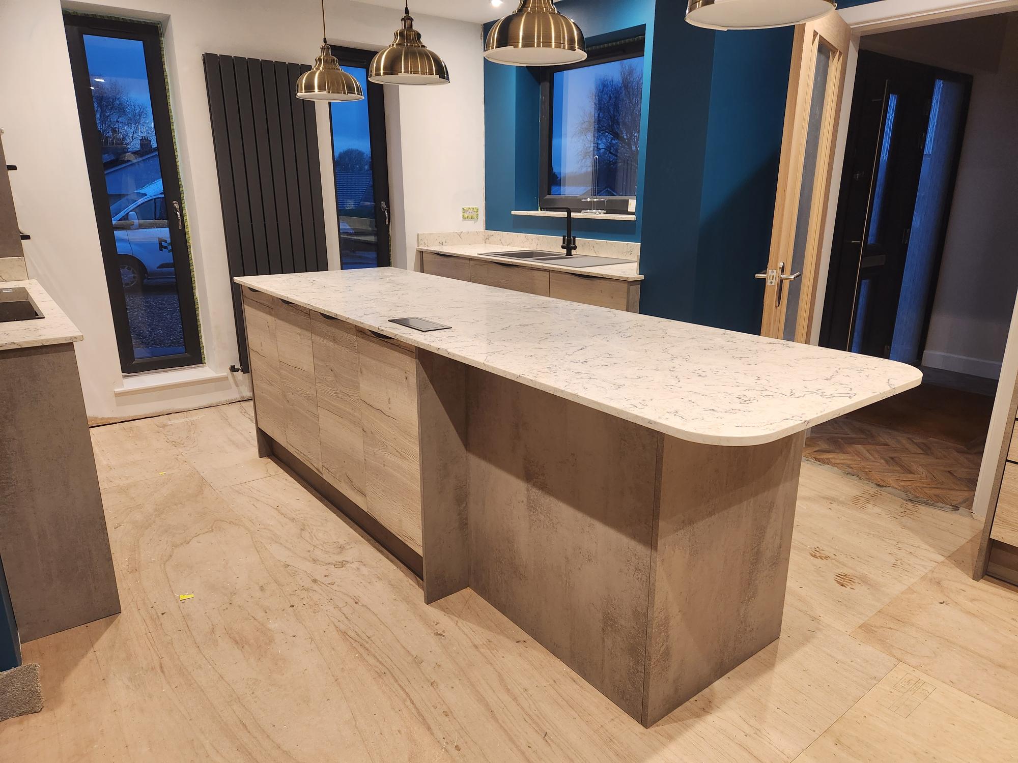 Modern kitchen with marble island and teal feature walls