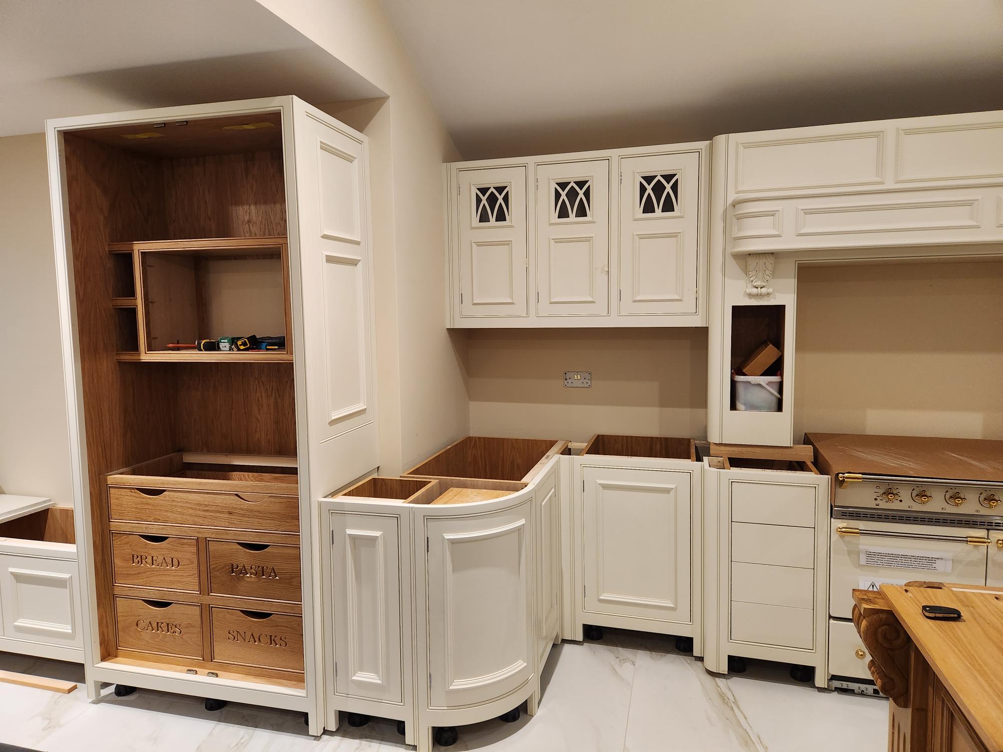 Traditional pantry larder with labelled oak drawers and gothic cabinet doors