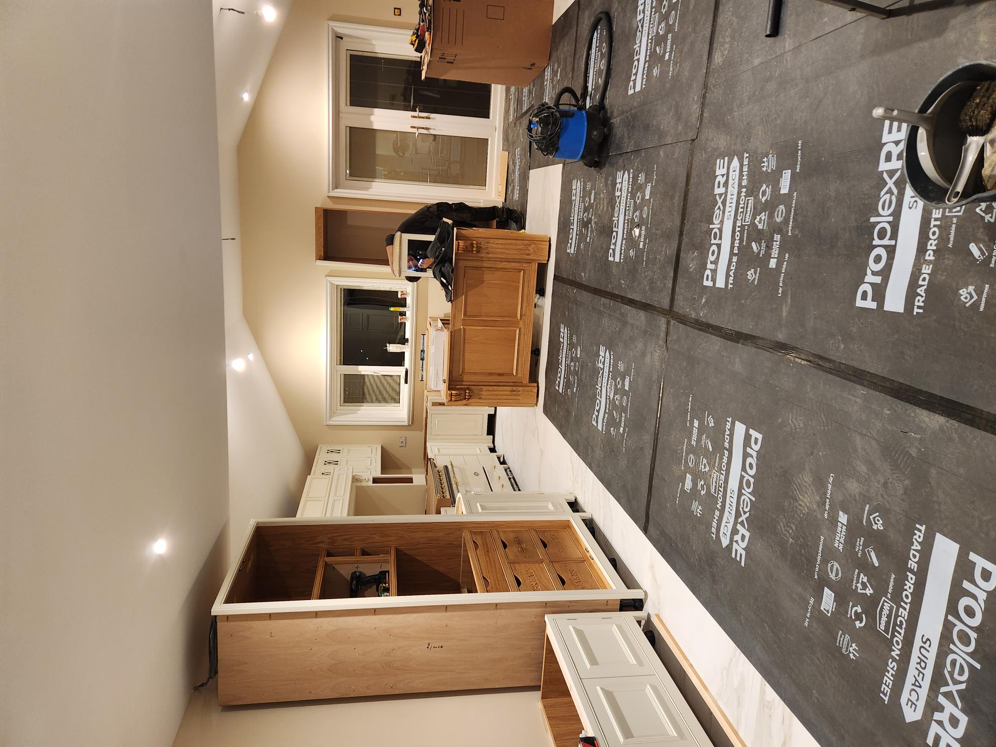 Large open plan kitchen with vaulted ceiling, oak island and cream cabinetry